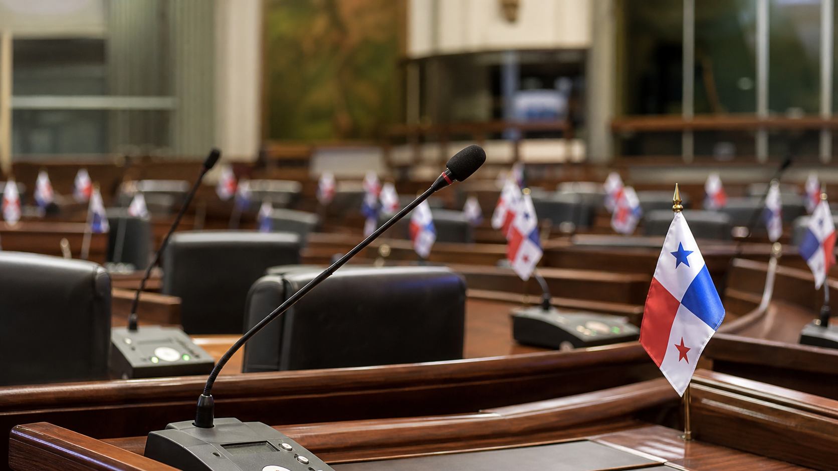 Legislative chamber desks during a debate on internal rules and transparency.