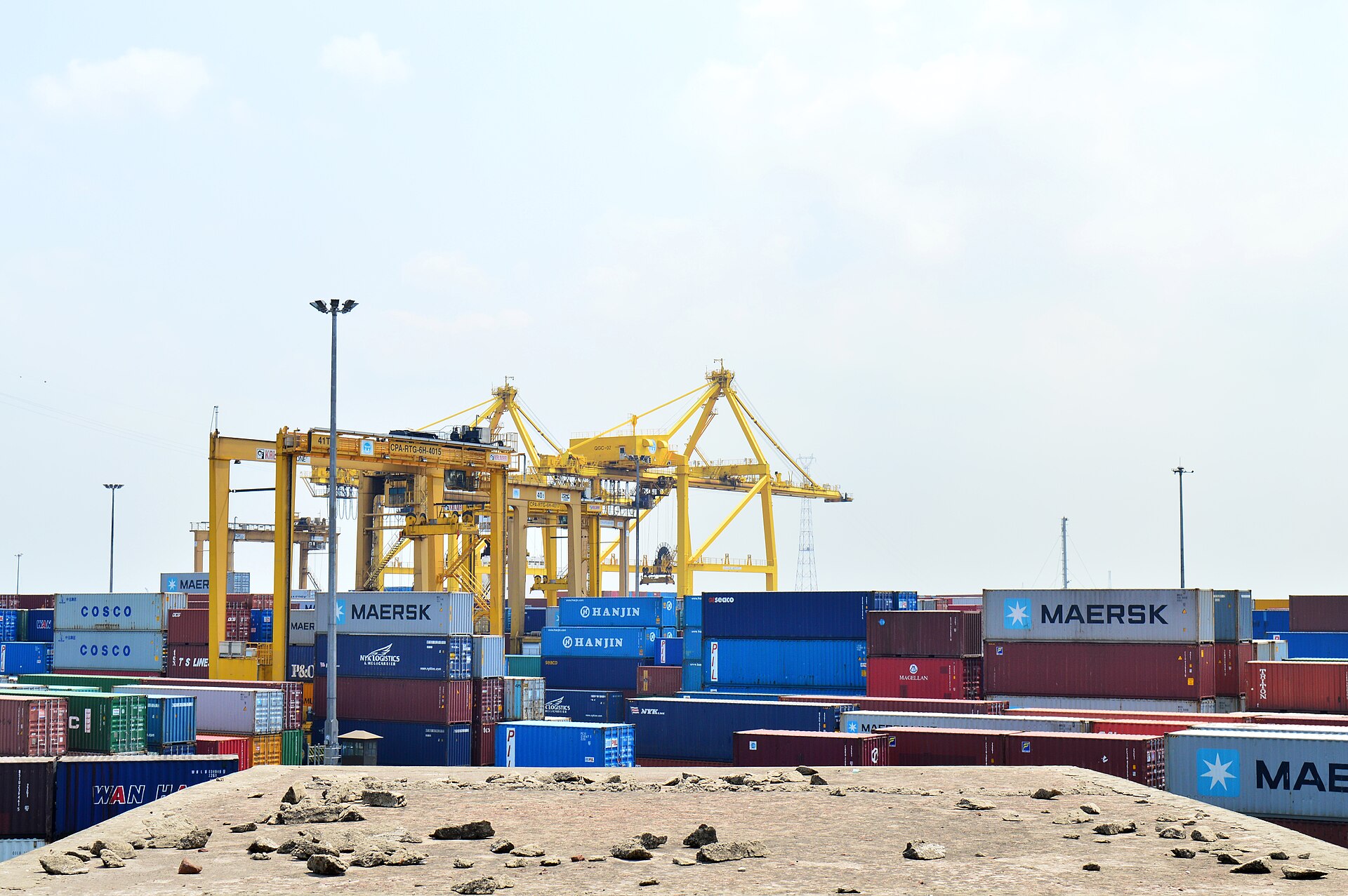 Stacked shipping containers at a port terminal (illustrative).