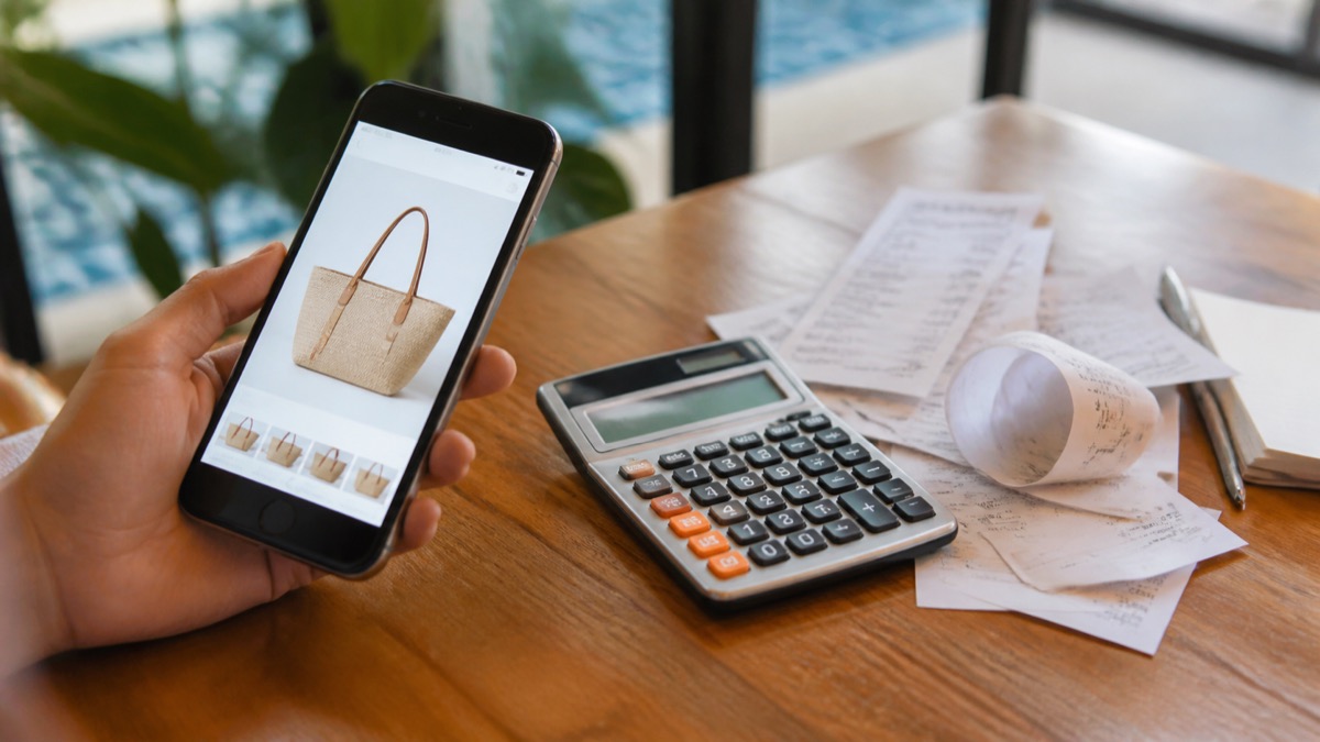 smartphone online purchase beside tax calculator and receipt