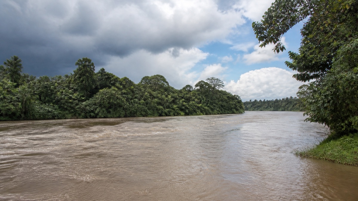 clearing storm clouds over a swollen tropical river in Bocas del Toro