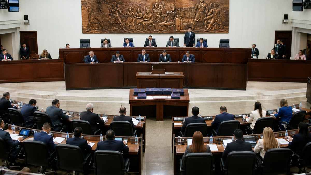wide view of a neutral legislative chamber in Panama during presentation of electoral reform documents, officials seen from a distance, no readable papers